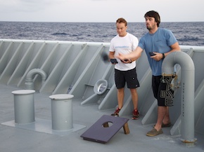 Lucas and Carlos, the Thompson's second and third mates play cornhole against each other on the bow.