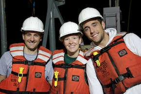Tom, Adrienne, and Nick in hard hats and life jackets, looking happy at 4 am.