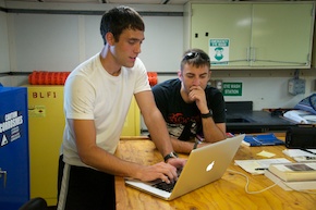 Nick and Tom work in the lab together to write a blog entry.