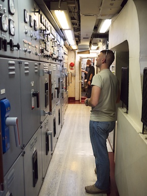 Tom looks at a while of dials and knobs that operate the engines.