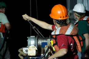 Pam runs a winch that lowers and raises the seismic air guns from the water.