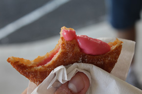 A malasada, a sugary donut filled with sweet fruit filling, it comes from heaven, direct.